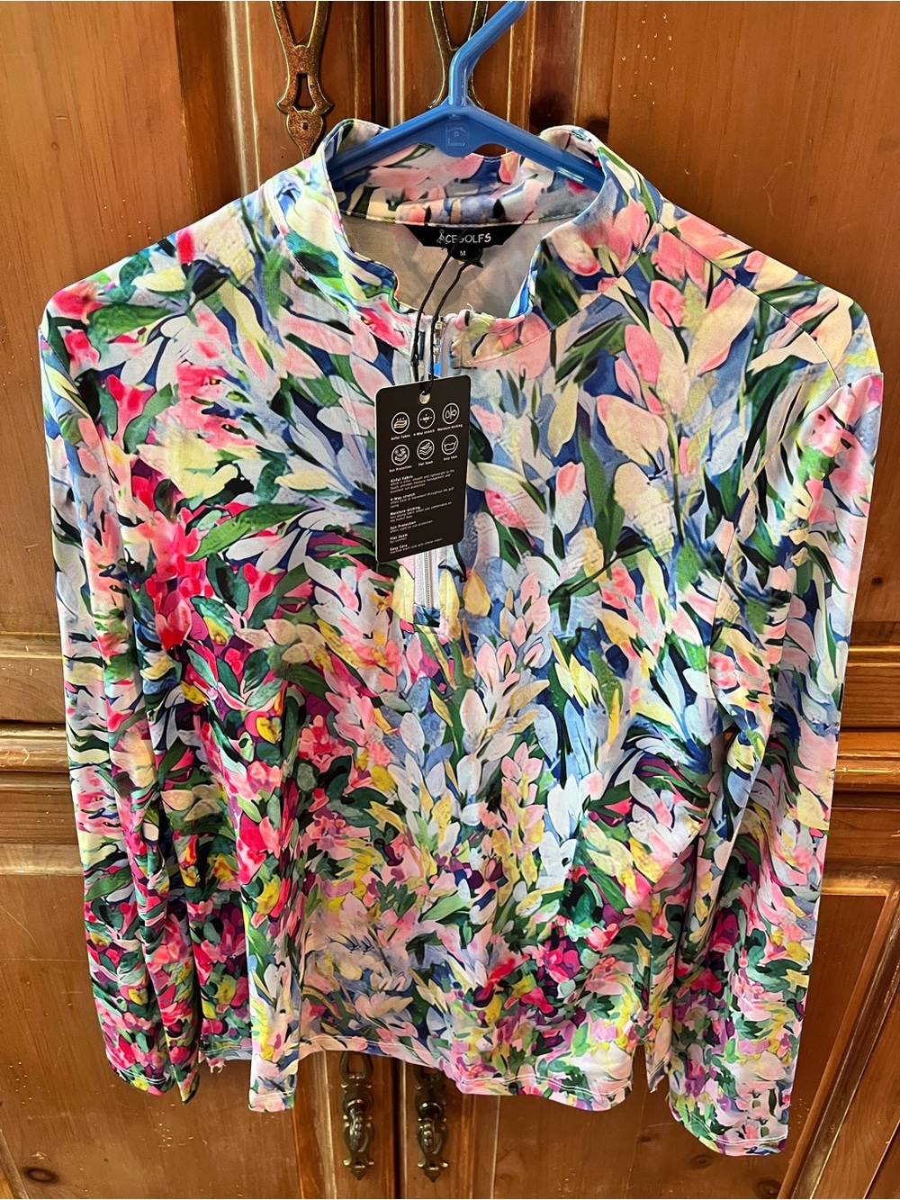 ACE GOLFS. NEW WITH TAGS. MEDIUM. MULTI COLOR TULIPS. QUARTER ZIP TOP